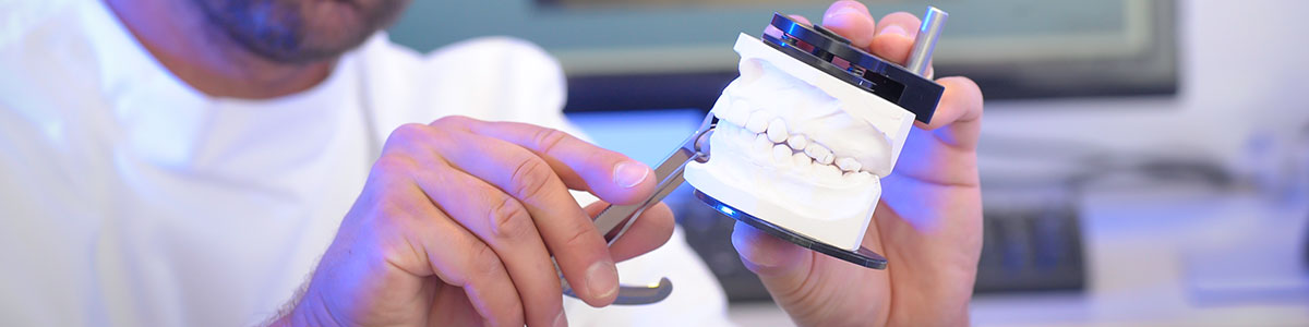 dental techinican finishing restoration with articulator