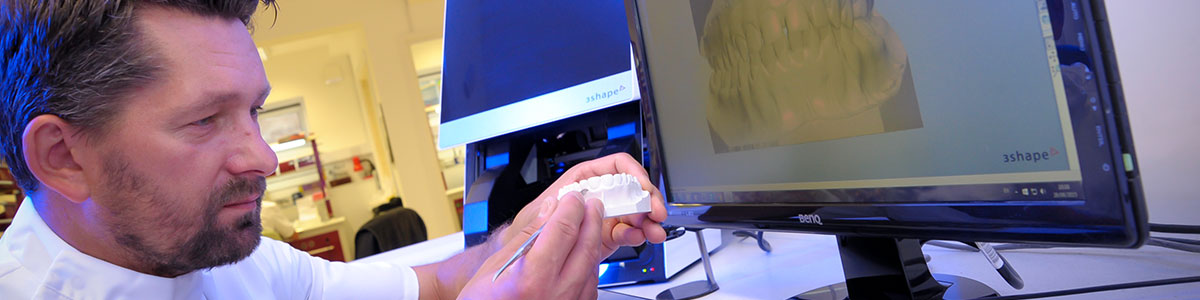 Dental technican performing 3d CADCAM implant restoration